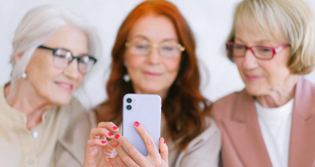 Senior women using smartphone while surfing internet