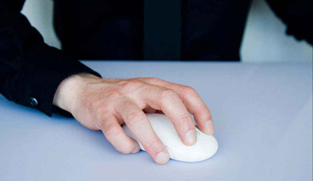 person holding white cordless computer mouse